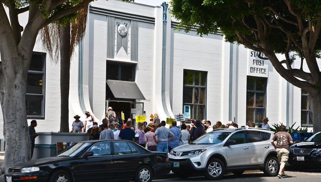 Photo caption: Over 90 people gathered for the Conservancy’s rally for the preservation of the historic 5th Street Post Office on June 29, 2013, its last day of operation Photo Credit Mike Crosby 