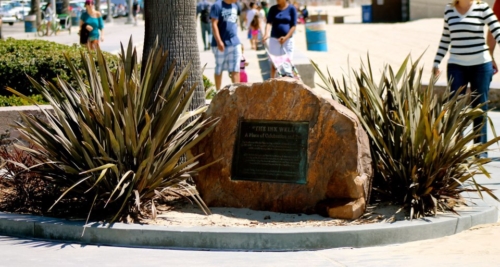 Photo of a dark black on a rock describing the Bay Street Beach historic site under its controversial nickname "The Inkwell"