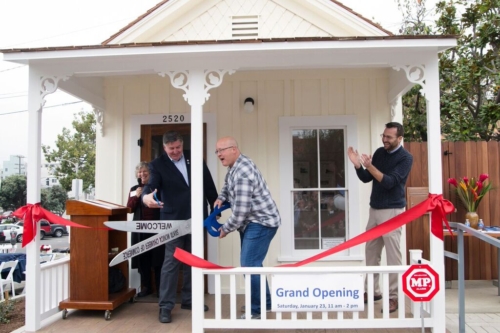 Pictured are Carol Lemlein, Former Councilmembers Kevin McKeown and Ted Winterer, and State Senator Ben Allen at the Shotgun House grand opening. The councilmen are holding scissors to perform a ribbon cutting, signifying the grand opening of the Preservation Resource Center at the Shotgun House on January 23, 2016.