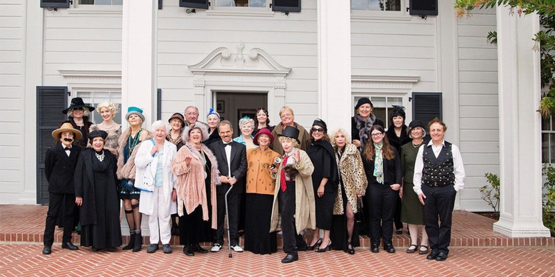 Annenberg docents pose in 1920s costumes in front of the beach house.