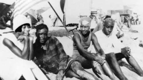 Photo of four people enjoying their time at the beach