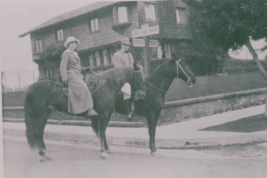 R.C. Gillis and his wife on horseback at the Gillis House
