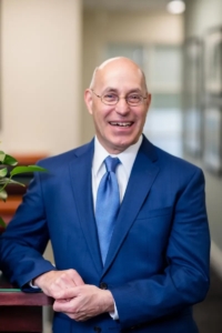 Medium Shot of Ken Kutcher in a Blue Jacket and Tie